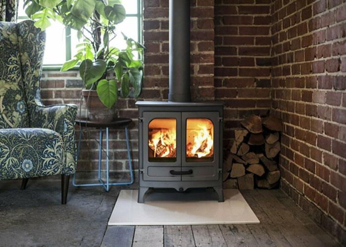 The Charnwood Island 2 Wood Burning Stove with a lit fire inside.